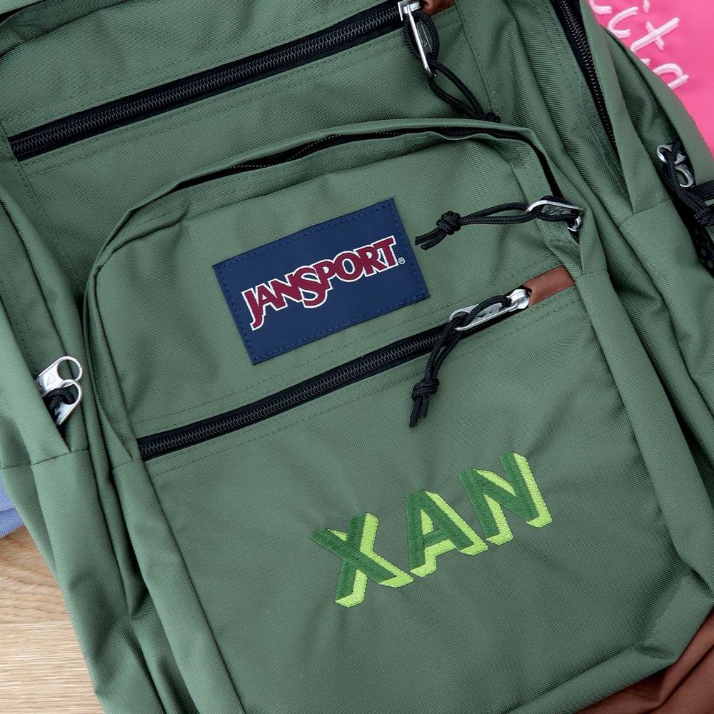 Green Jansport backpack with large lime-green name embroidery